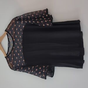 Flowing flirty top with sheer neckline and shoulders